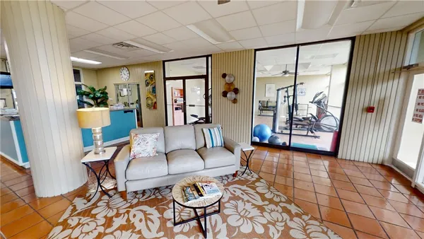a living room with furniture and a floor to ceiling window
