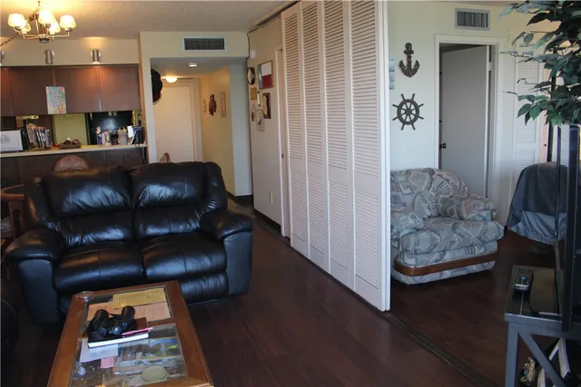 a living room with furniture and a wooden floor