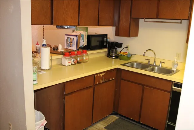a kitchen with sink and cabinets