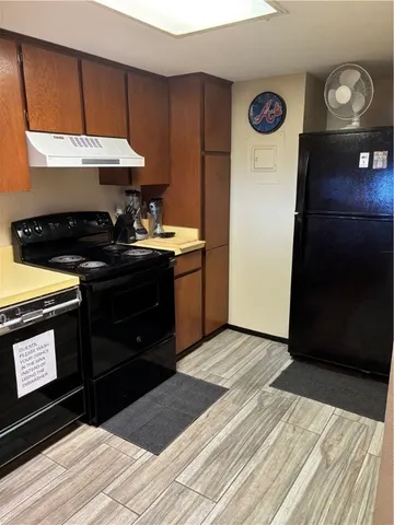 a kitchen with a stove and a refrigerator