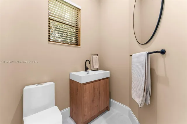 a bathroom with a toilet sink and a mirror