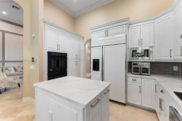 a kitchen with stainless steel appliances a refrigerator sink and cabinets