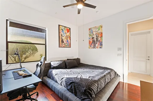 a bedroom with a bed and a painting on the wall