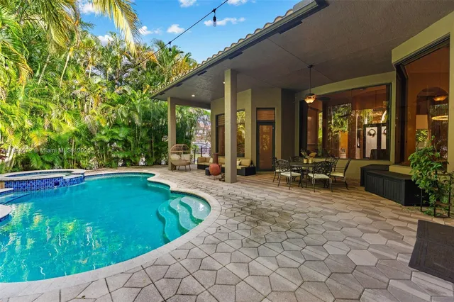 a swimming pool with outdoor seating