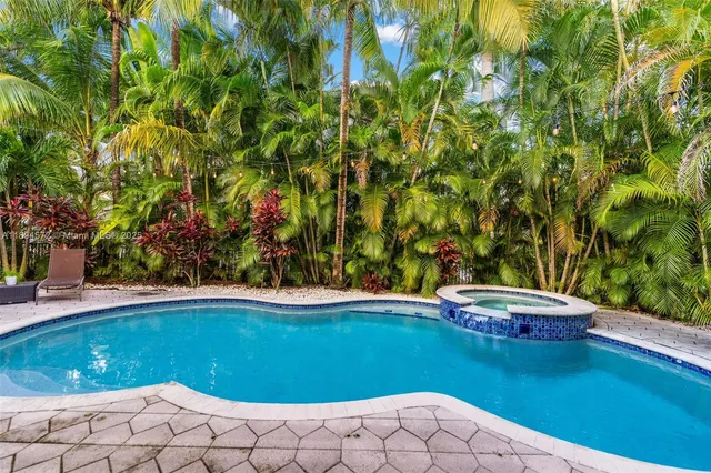a view of a swimming pool with an outdoor space and seating area