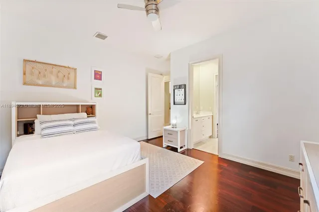 a room with a bed and wooden floor