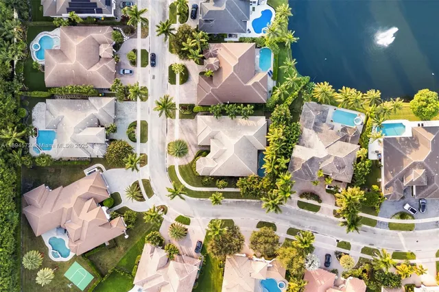 an aerial view of a house with a yard and swimming pool
