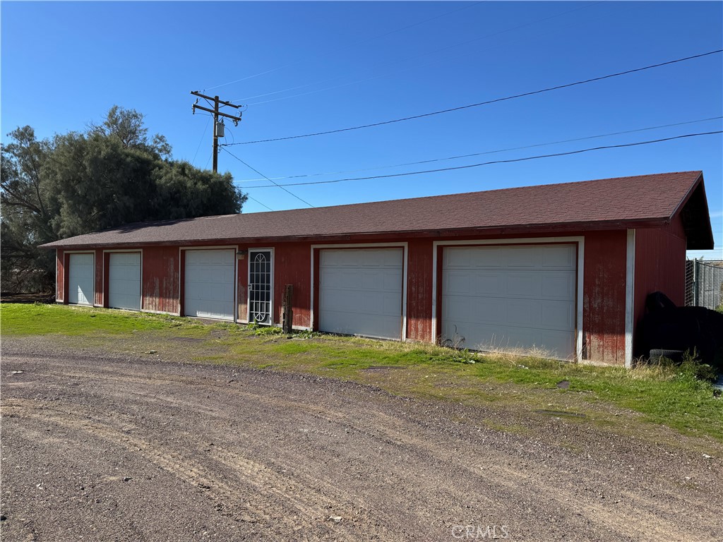 36708 Irwin Road Barstow, CA 92311 - Photo 12 of 16 a front view of a house with a yard and garage
