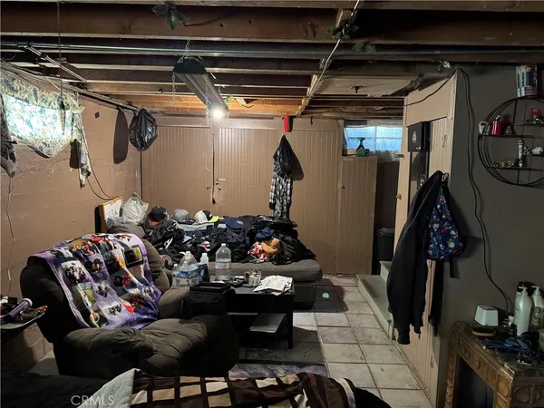 a living room with lots of furniture and clutter