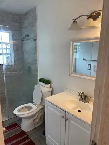 a white toilet sitting next to a bathroom sink