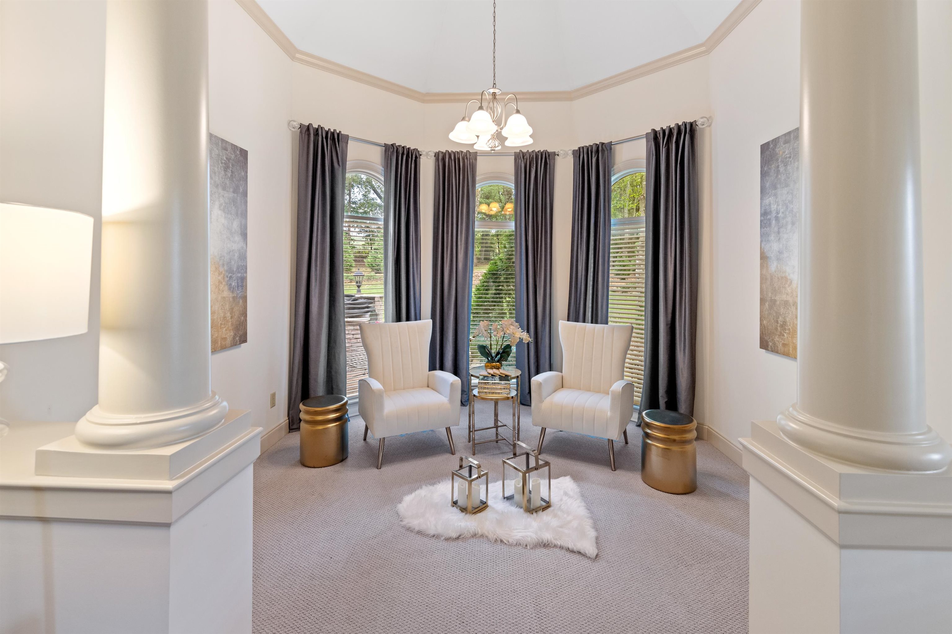 11241 Latting Road Eads, TN 38028 - Photo 19 of 31 Living area featuring carpet floors, a healthy amount of sunlight, decorative columns, and a notable chandelier