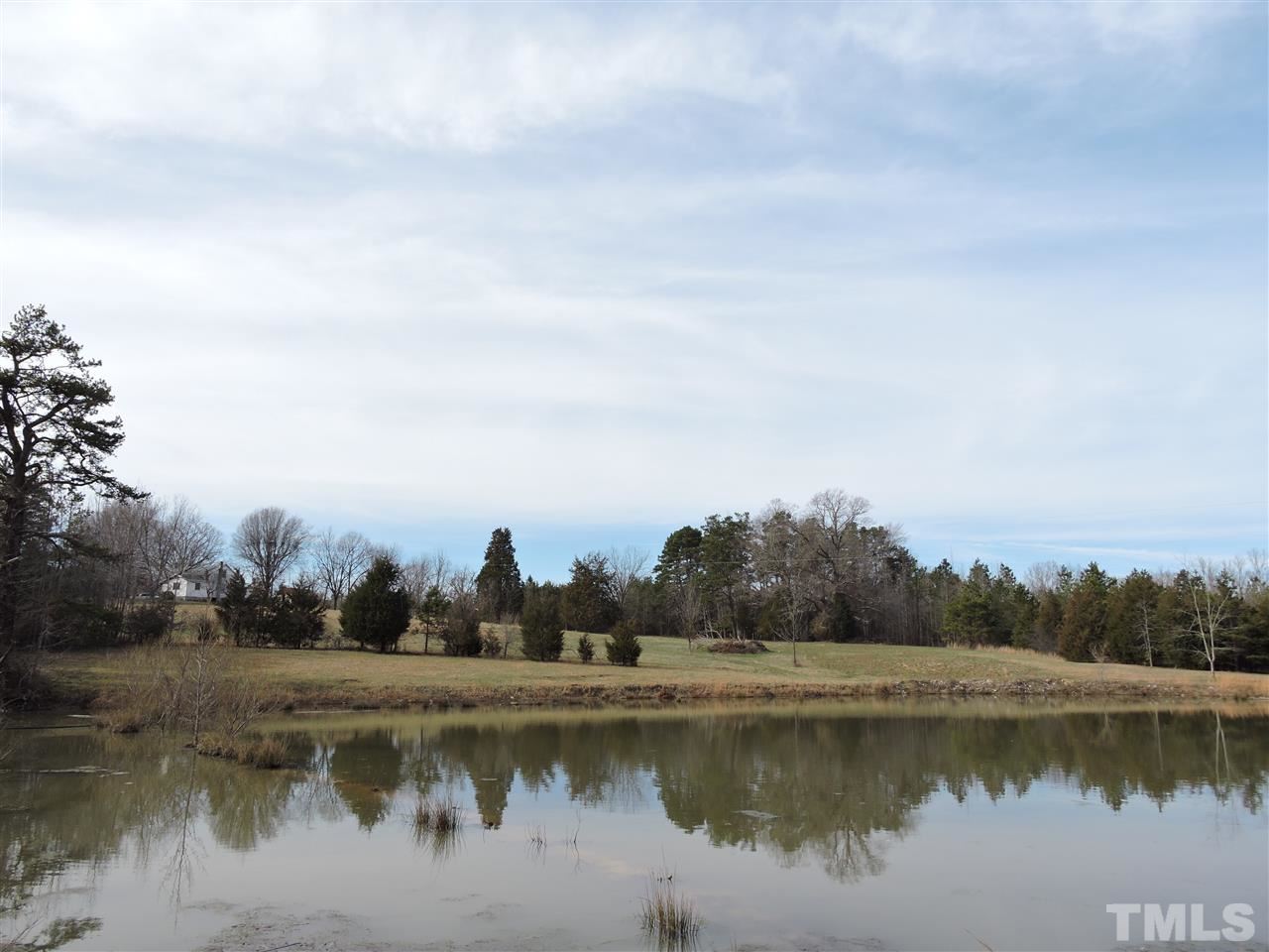 8320 Bacon Road Timberlake, NC 27583 - Photo 2 of 21 a view of a lake with houses in the back
