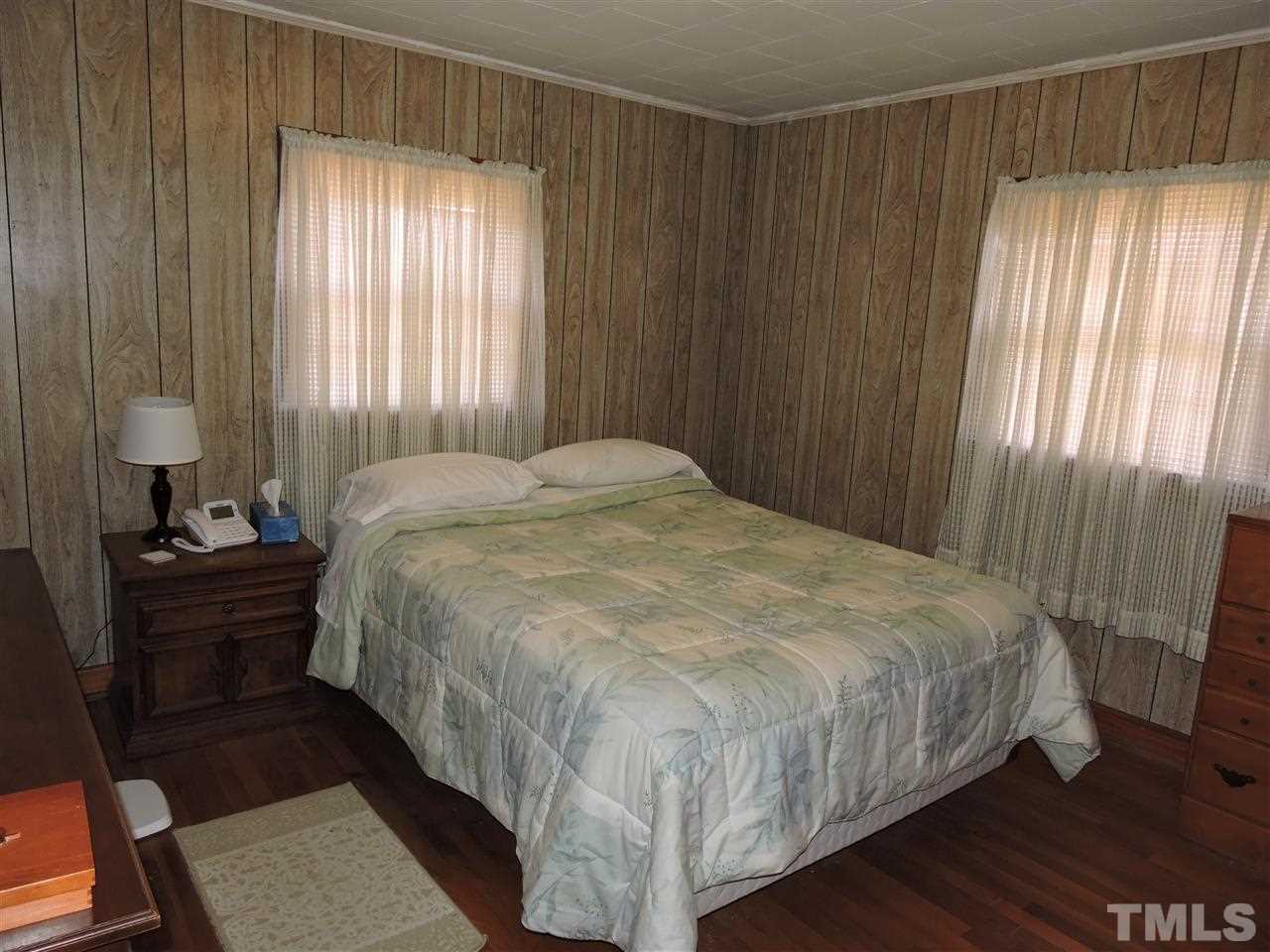 8320 Bacon Road Timberlake, NC 27583 - Photo 20 of 21 a bedroom with a bed lamp and a window