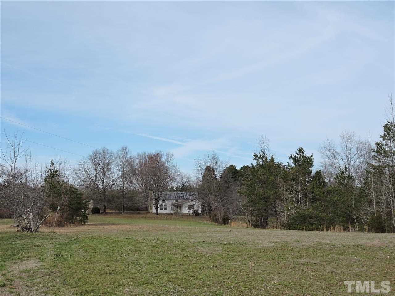 8320 Bacon Road Timberlake, NC 27583 - Photo 7 of 21 a view of a field with trees in the background