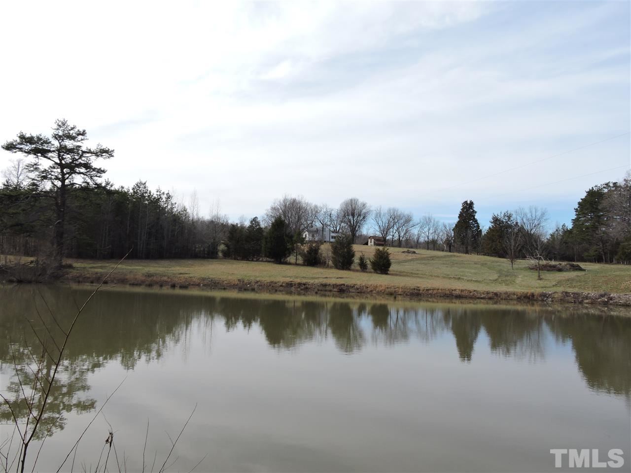 8320 Bacon Road Timberlake, NC 27583 - Photo 8 of 21 a view of a lake with houses in the back