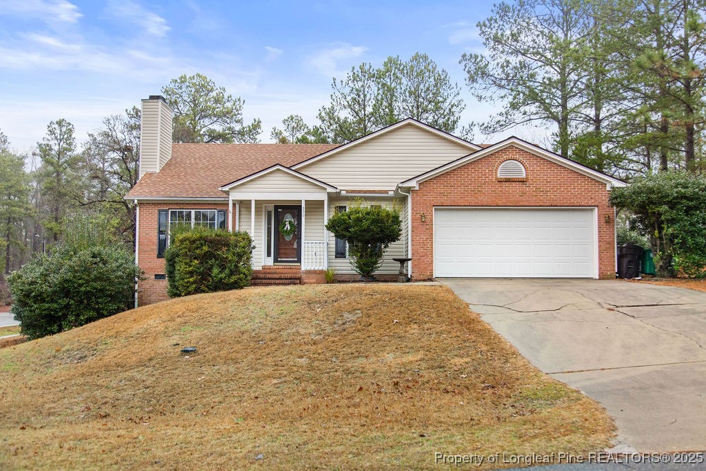 330 Fox Run Road Pinehurst, NC 28374 - Photo 1 of 31 a front view of a house with a yard and garage