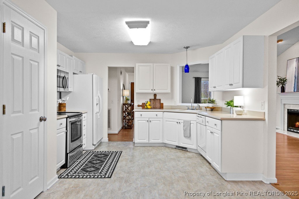 330 Fox Run Road Pinehurst, NC 28374 - Photo 11 of 31 a kitchen with cabinets and stainless steel appliances
