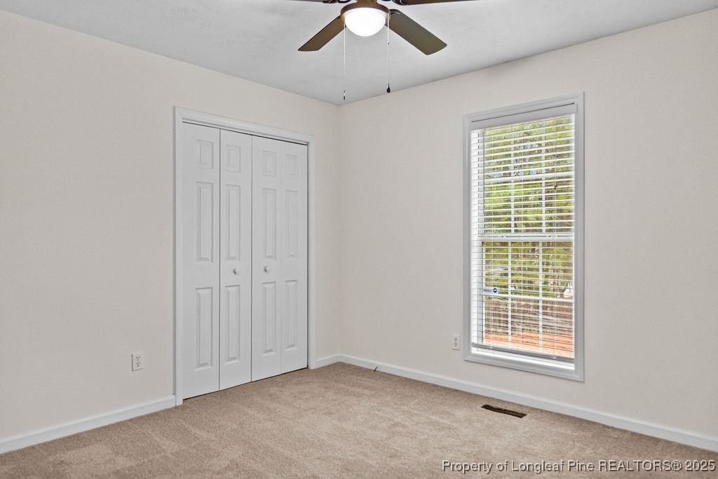 330 Fox Run Road Pinehurst, NC 28374 - Photo 19 of 31 a view of an empty room with window and chandelier fan