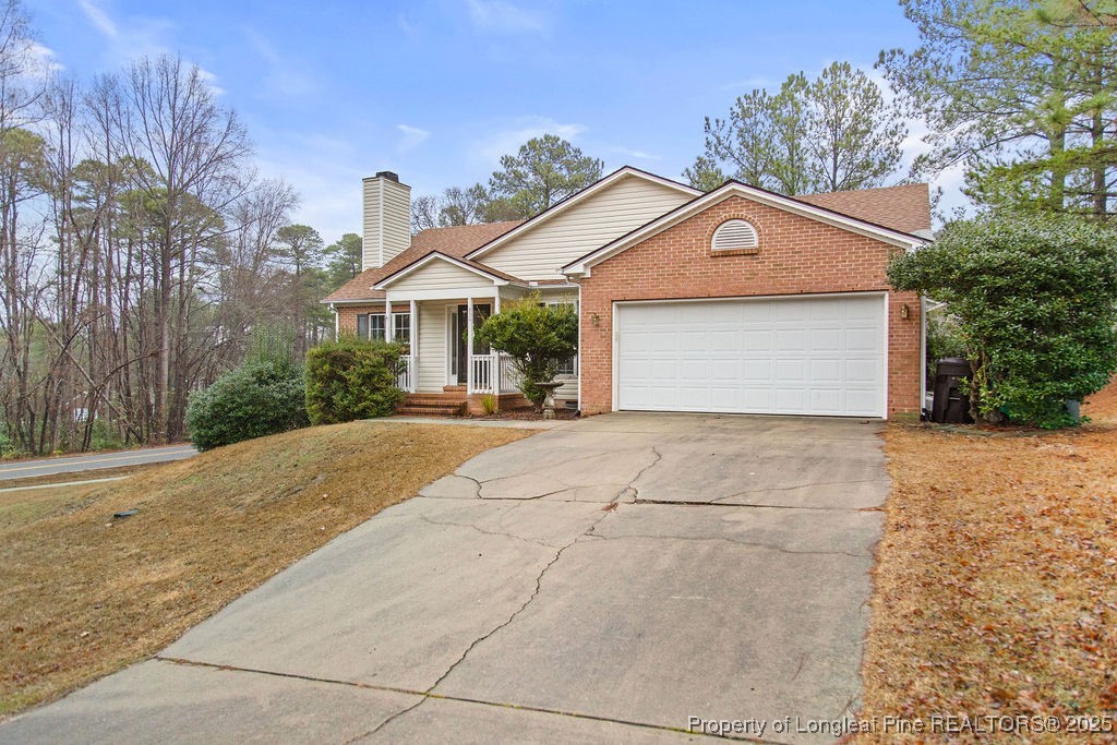 330 Fox Run Road Pinehurst, NC 28374 - Photo 2 of 31 a front view of a house with a yard and garage