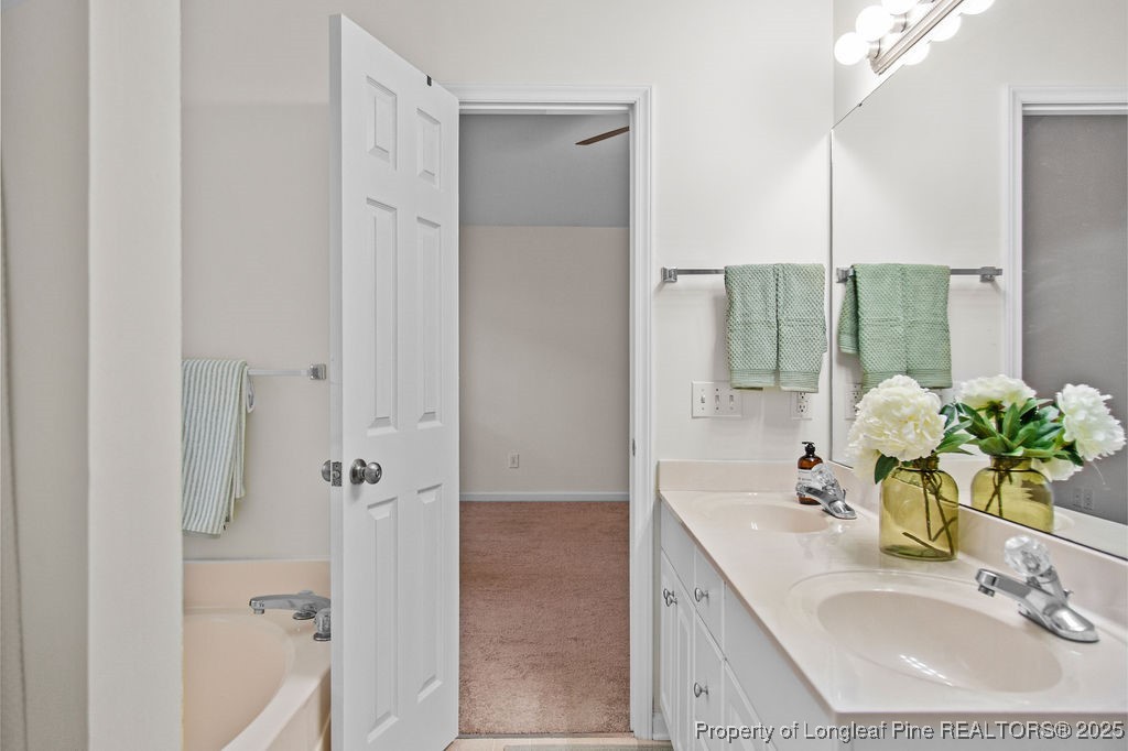 330 Fox Run Road Pinehurst, NC 28374 - Photo 24 of 31 a bathroom with a granite countertop shower sink and mirror