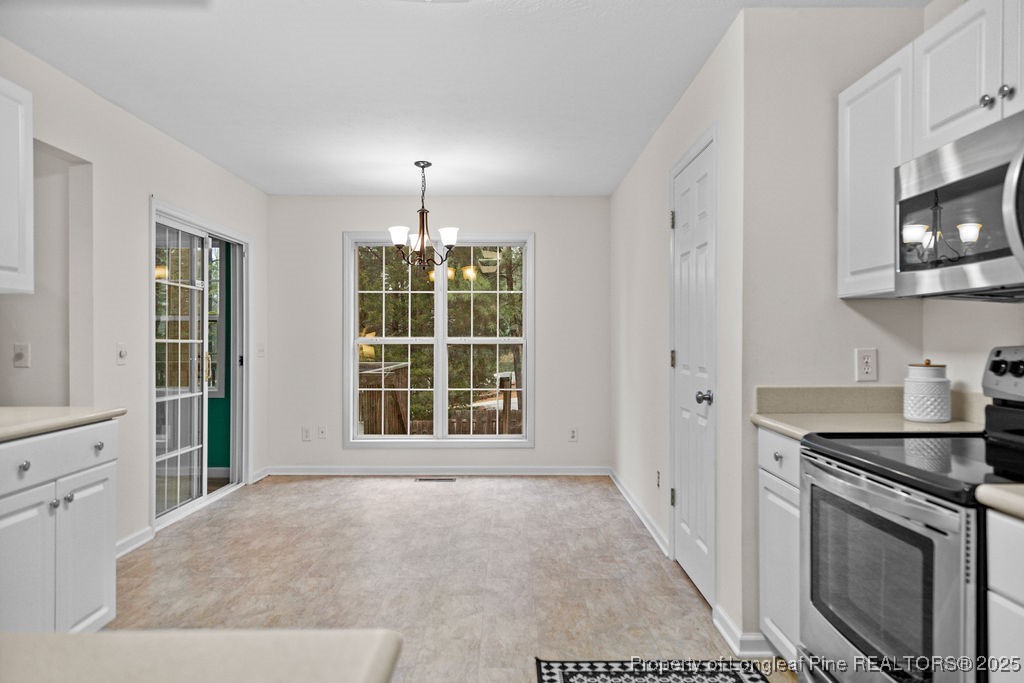 330 Fox Run Road Pinehurst, NC 28374 - Photo 9 of 31 a view of an empty room with a fireplace and a window