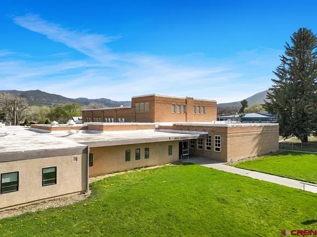a view of a house with a backyard space and a mountain view