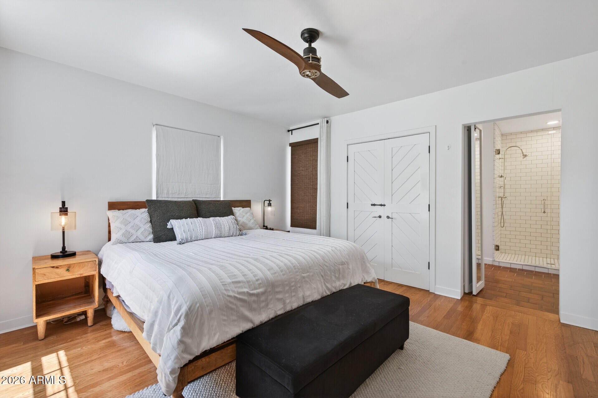 130 East Alvarado Road Phoenix, AZ 85004 - Photo 22 of 49 a bedroom with a bed and wooden floor