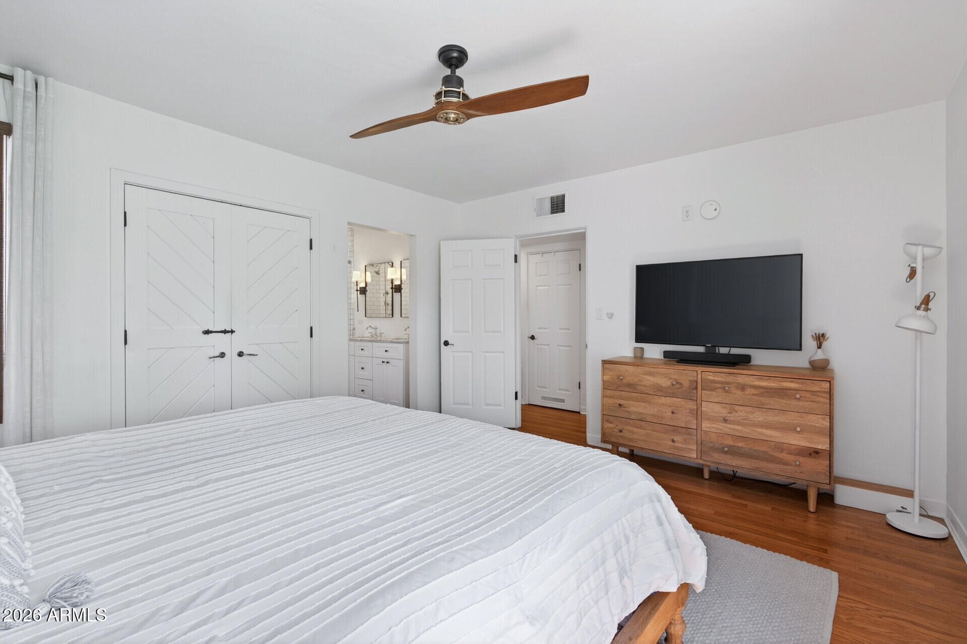 130 East Alvarado Road Phoenix, AZ 85004 - Photo 23 of 49 a bedroom with a bed and a flat screen tv