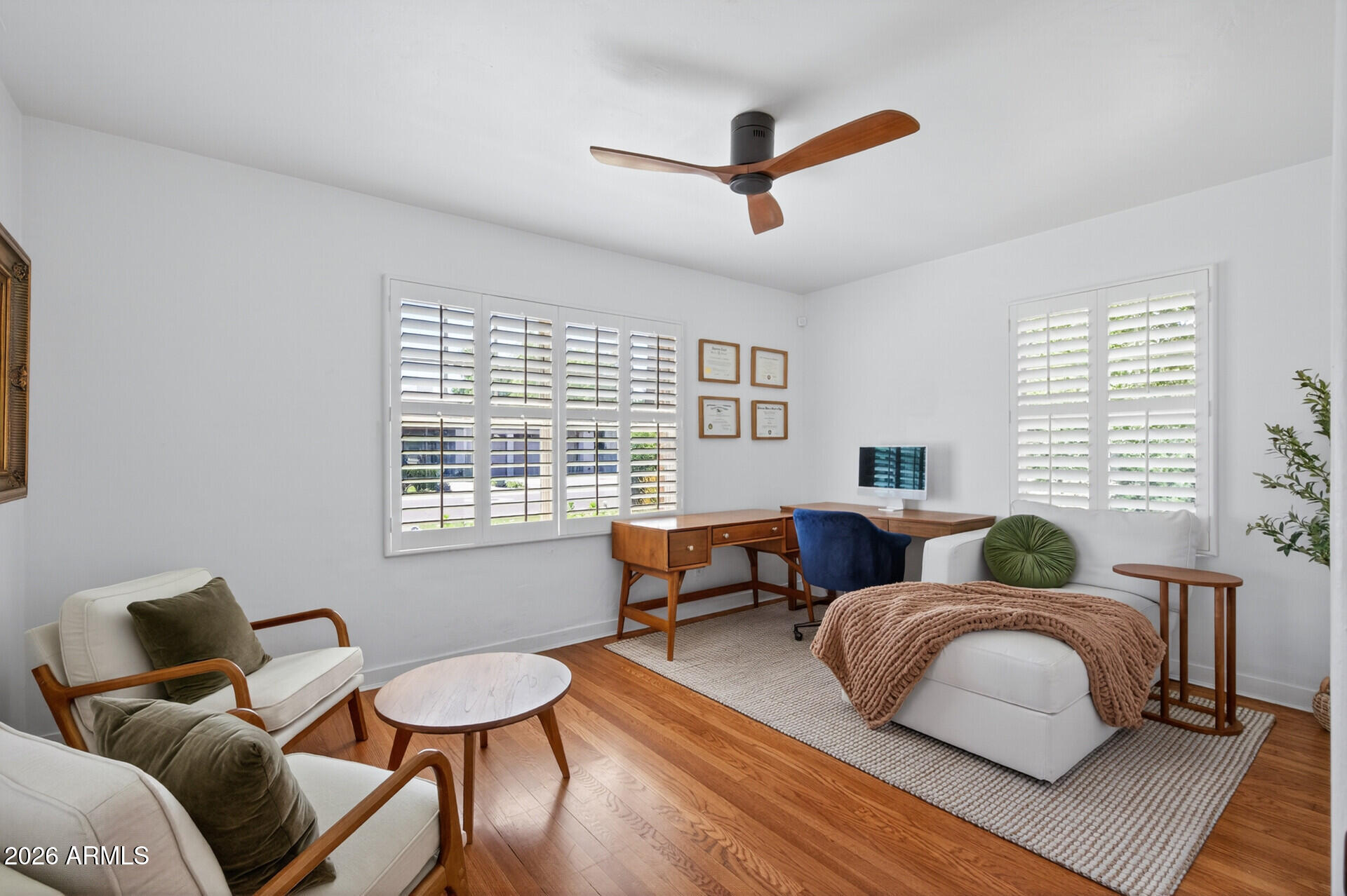 130 East Alvarado Road Phoenix, AZ 85004 - Photo 32 of 49 a bedroom with a bed and wooden floor