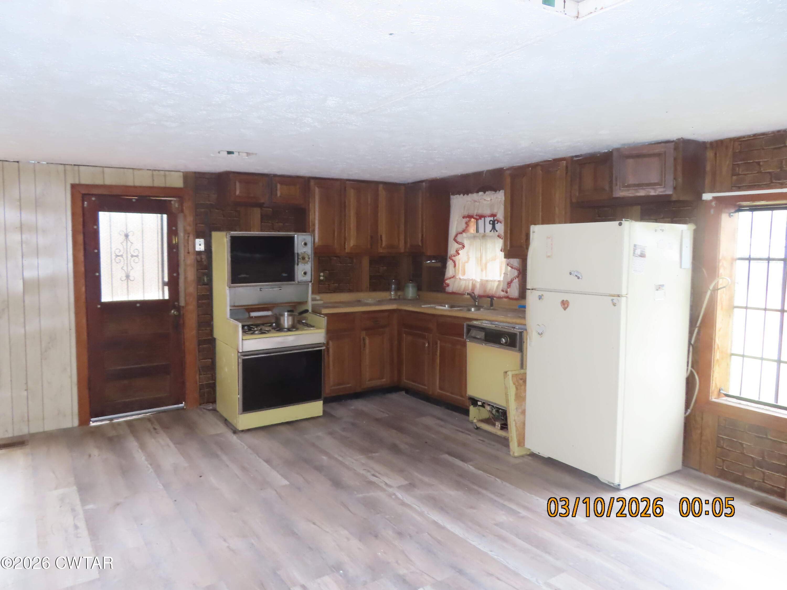 900 Hubberd Town Road Beech Bluff, TN 38313 - Photo 3 of 19 a kitchen with a refrigerator sink and cabinets