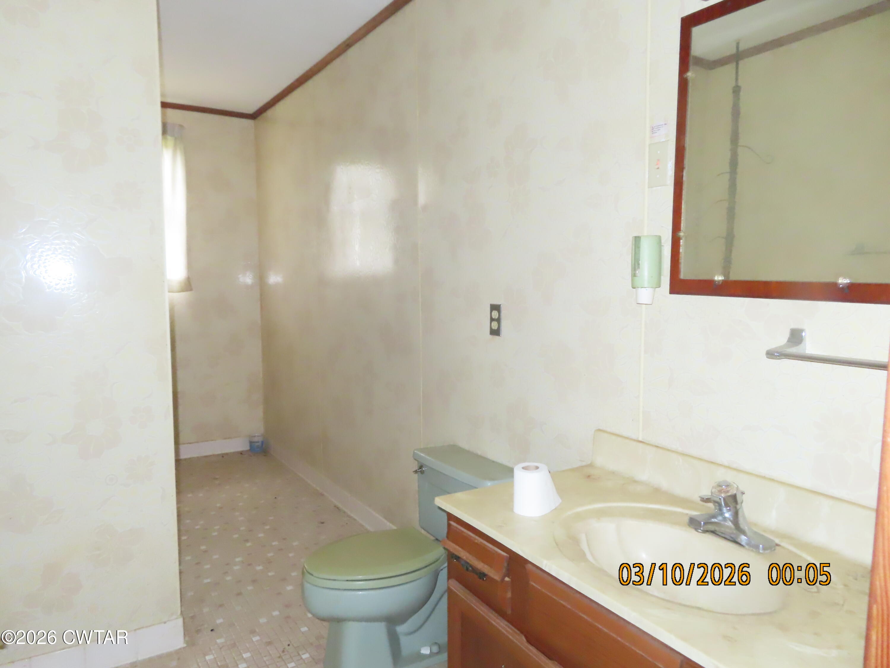 900 Hubberd Town Road Beech Bluff, TN 38313 - Photo 10 of 19 a bathroom with a sink a toilet and a mirror