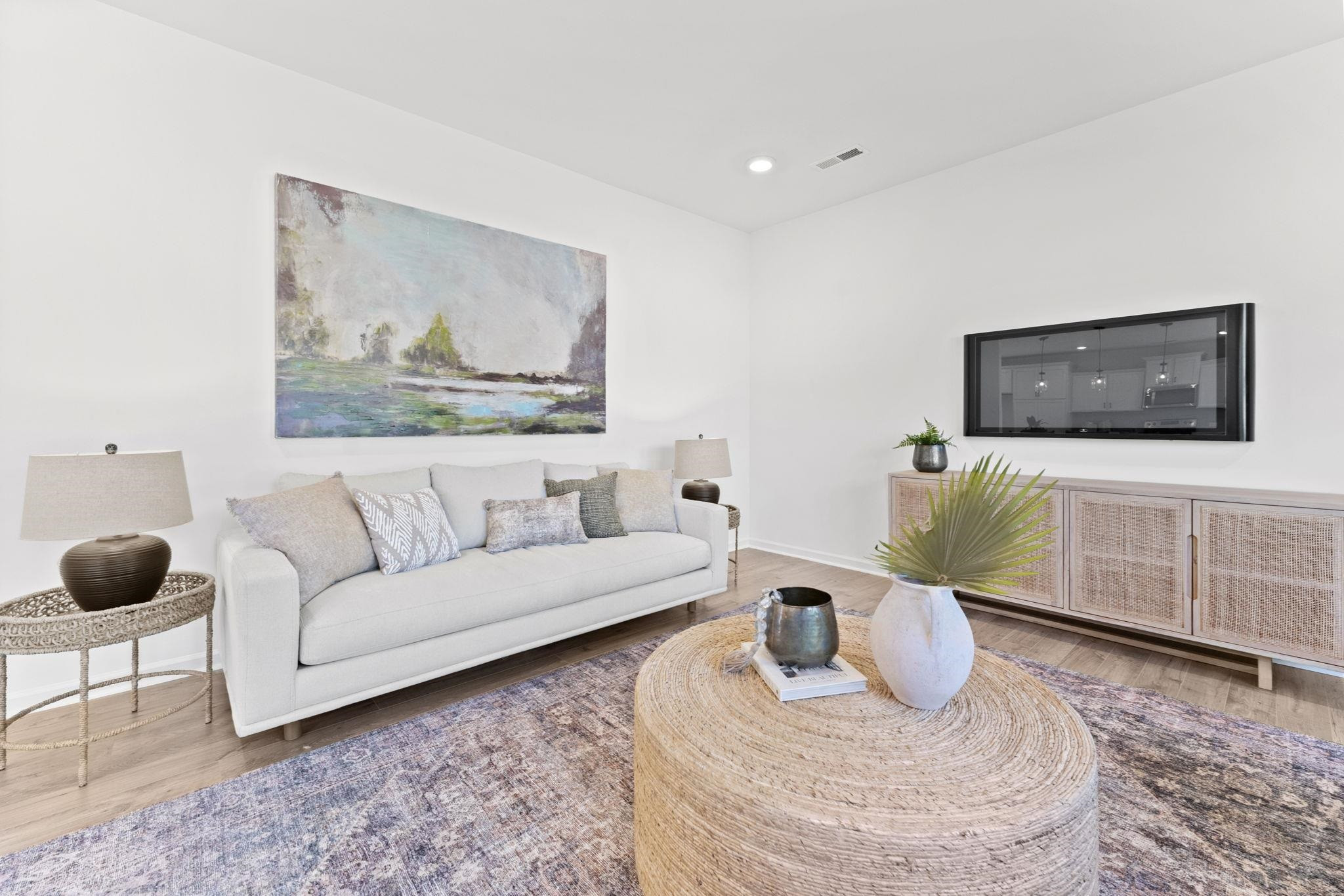 402 Cliff Court, Unit 9 Benson, NC 27504 - Photo 11 of 25 a living room with furniture and a flat screen tv