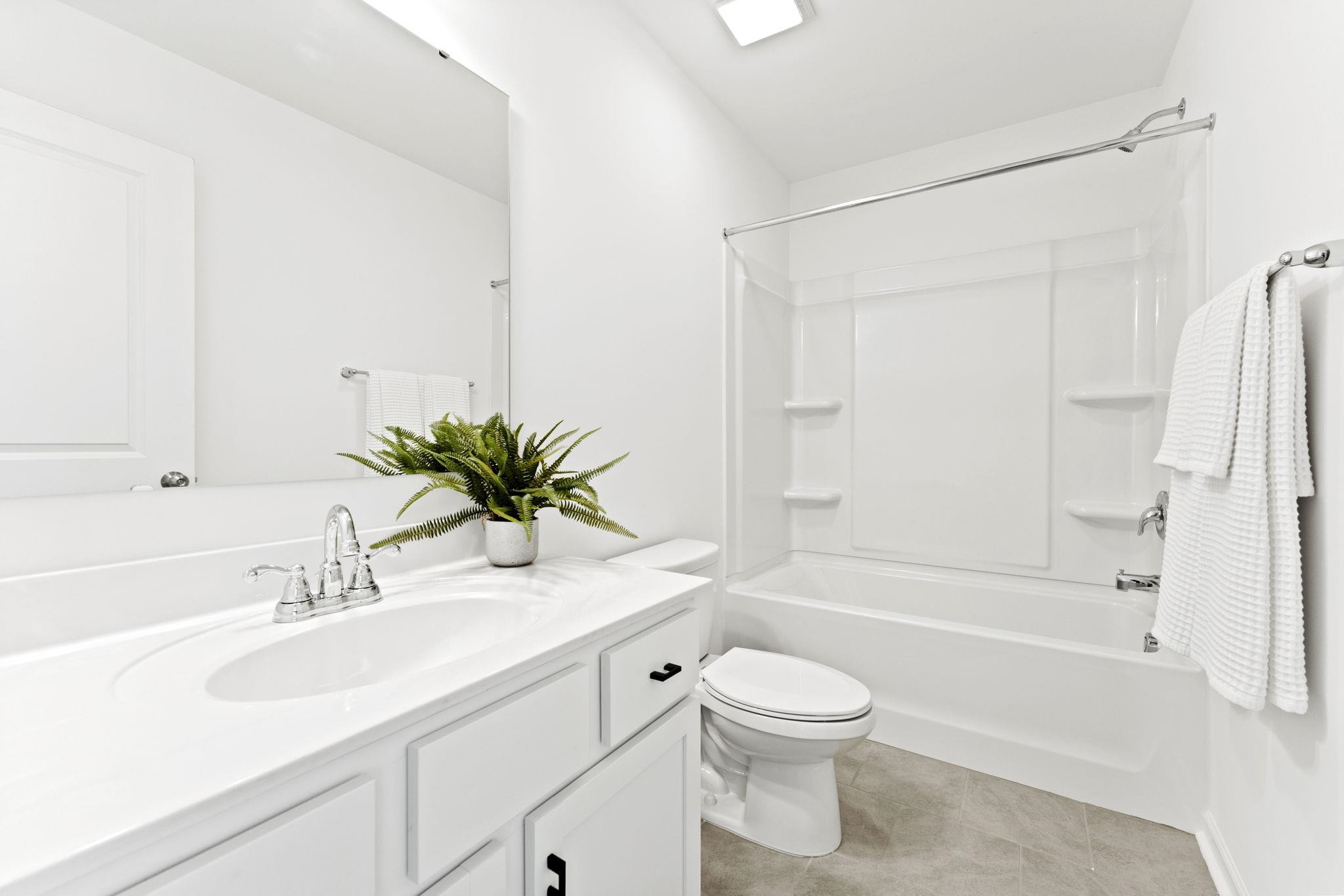 402 Cliff Court, Unit 9 Benson, NC 27504 - Photo 20 of 25 a bathroom with a sink a toilet and a bathtub