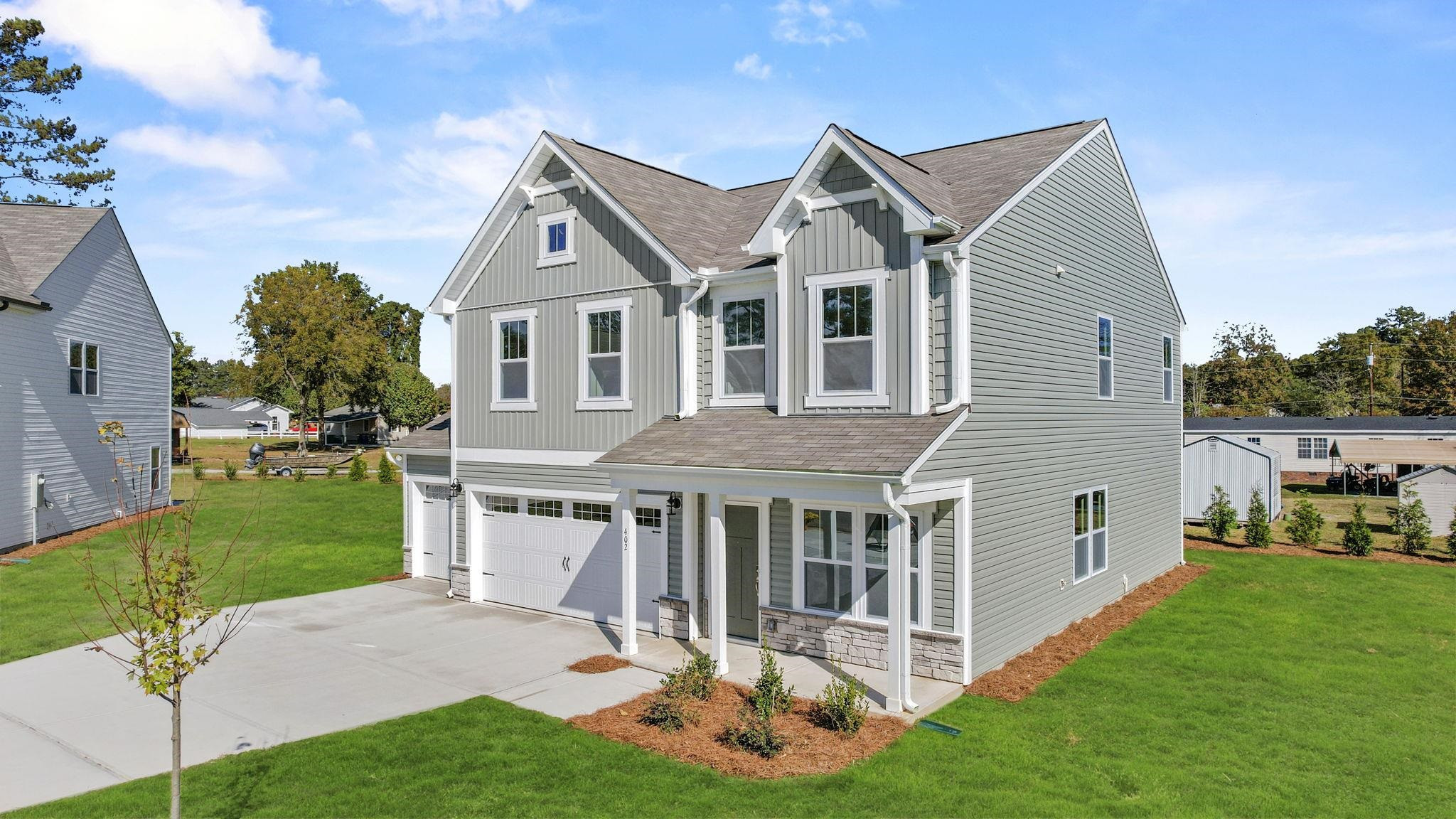 402 Cliff Court, Unit 9 Benson, NC 27504 - Photo 2 of 25 a aerial view of a house with a yard patio and a garden