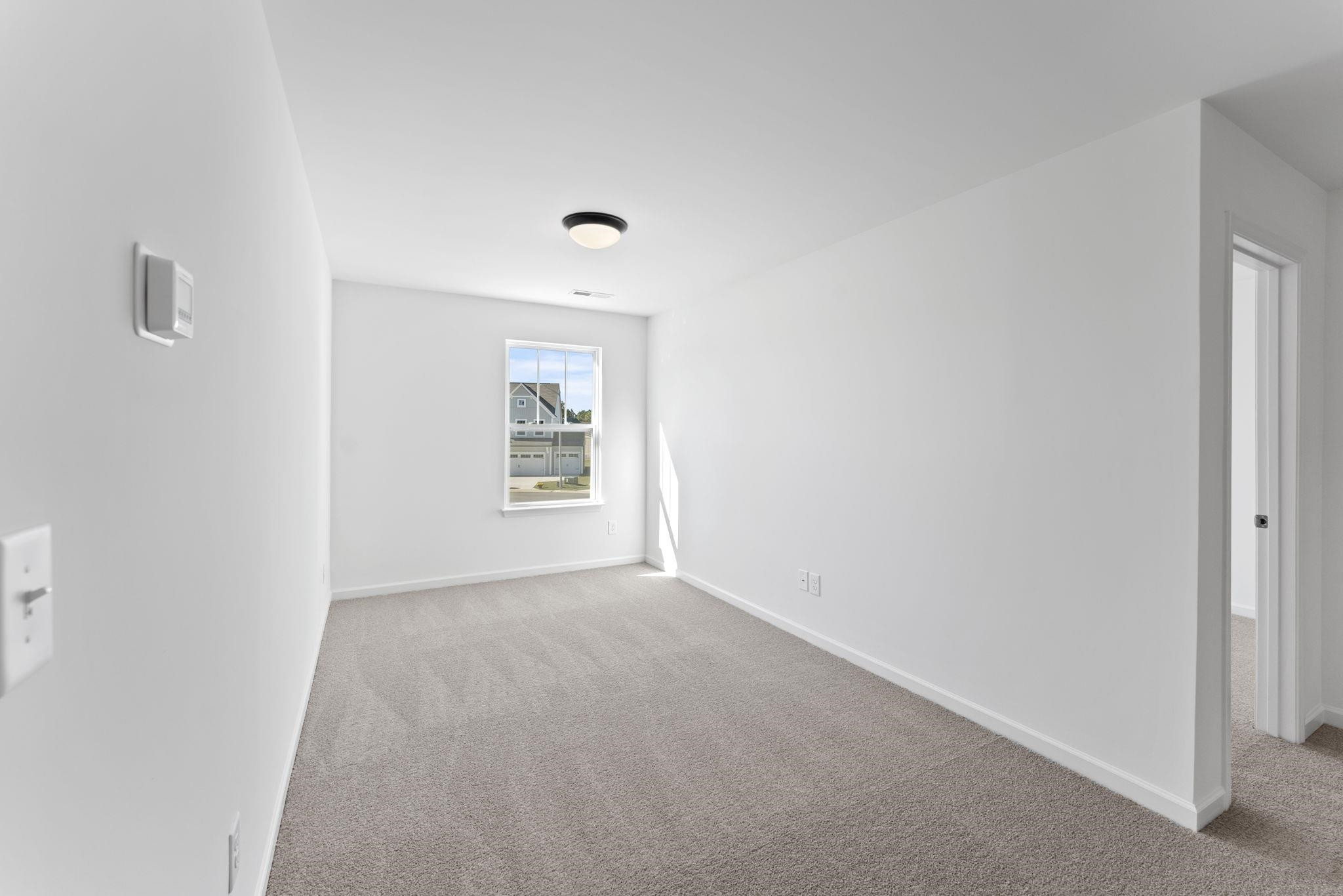 402 Cliff Court, Unit 9 Benson, NC 27504 - Photo 23 of 25 a view of an empty room with a window