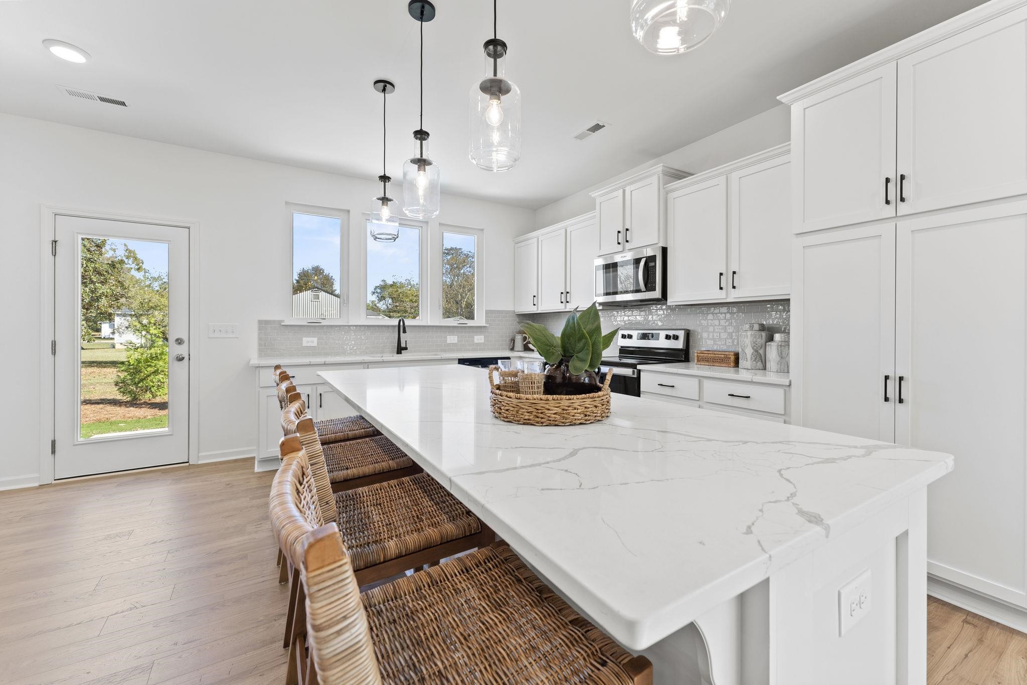402 Cliff Court, Unit 9 Benson, NC 27504 - Photo 5 of 25 a kitchen with kitchen island a stove a sink a dining table and chairs