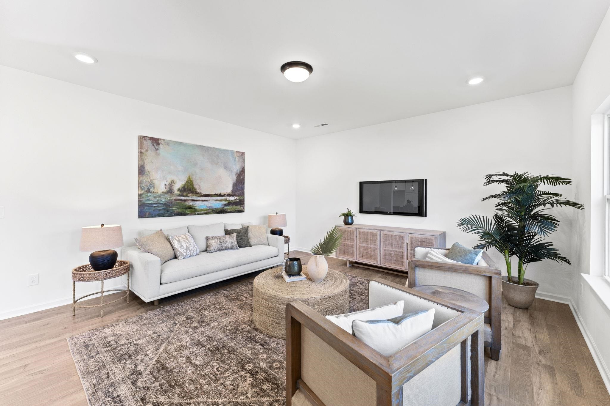 402 Cliff Court, Unit 9 Benson, NC 27504 - Photo 9 of 25 a living room with furniture and a flat screen tv