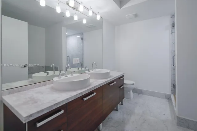 a spacious bathroom with a bathtub sink and mirror