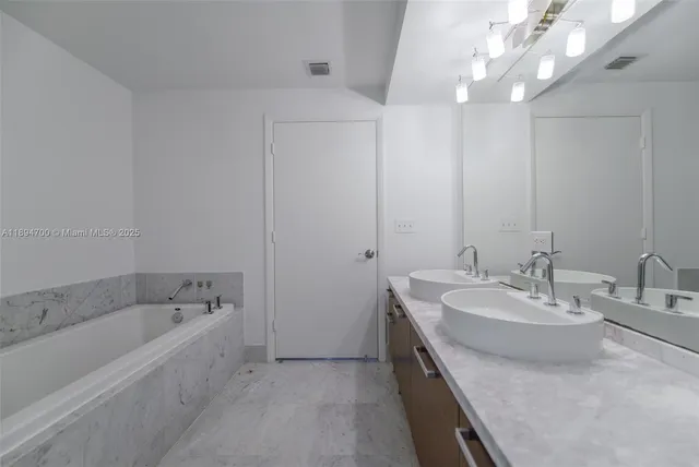 a bathroom with a bathtub and shower