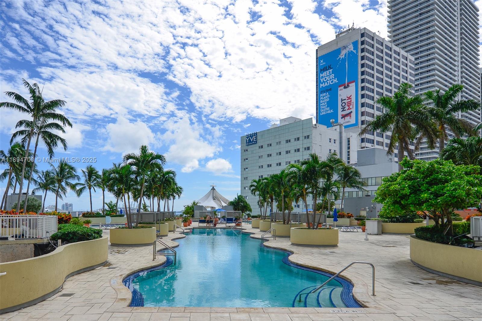 253 Northeast 2nd Street, Unit 3902 Miami, FL 33132 - Photo 31 of 47 a view of a swimming pool with couches and potted plants