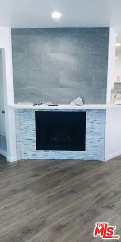 a view of a kitchen with sink dishwasher and wooden floor