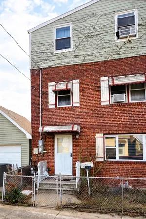 front view of a brick house with two windows
