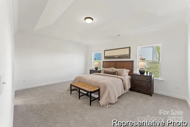 a bedroom with a bed and a lamp