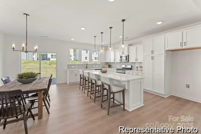 a view of kitchen with cabinets table and chairs