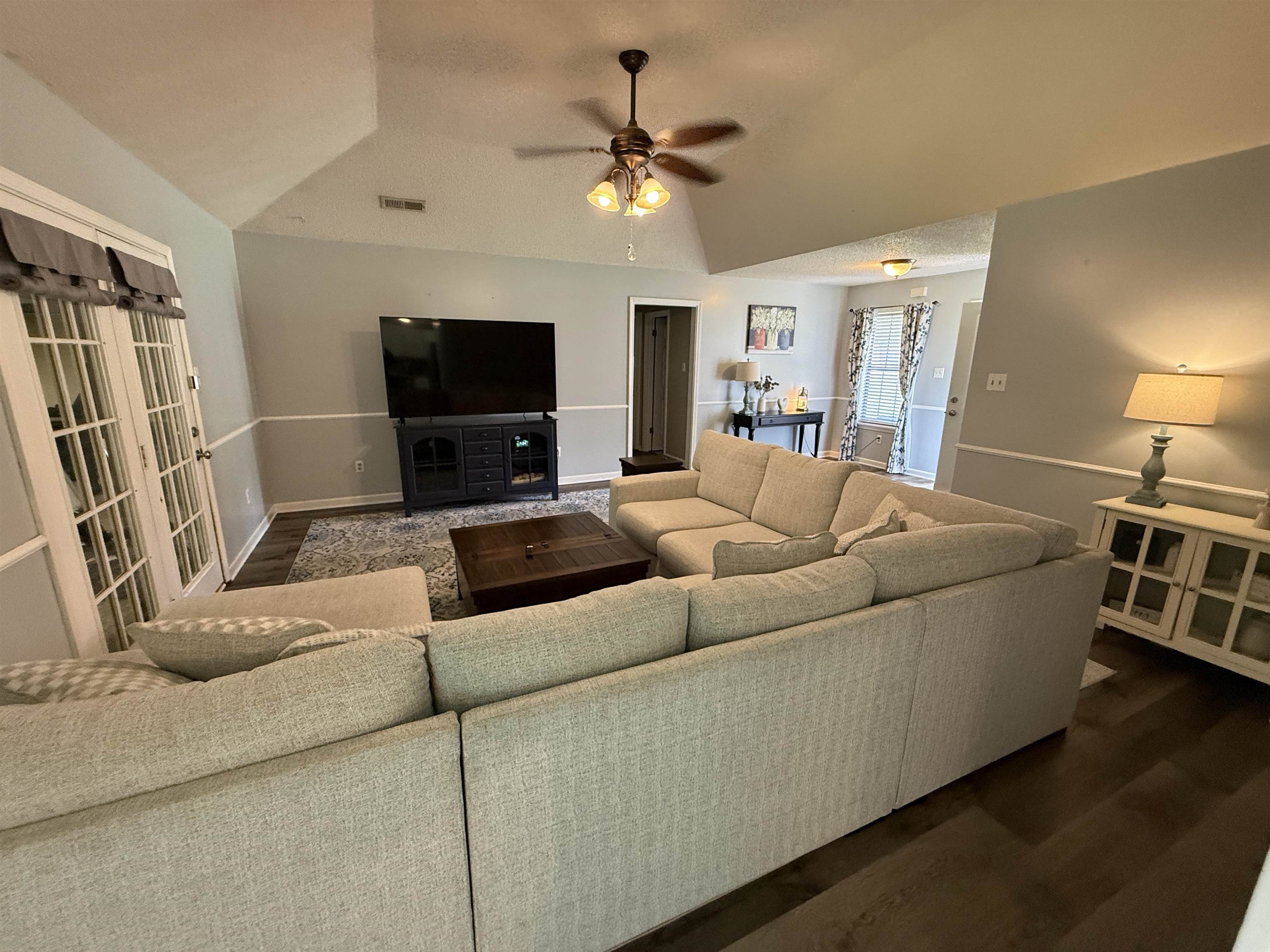 185 Mignon Road Atoka, TN 38004 - Photo 10 of 34 Living area featuring vaulted ceilings, wood-finish flooring, and a ceiling fan
