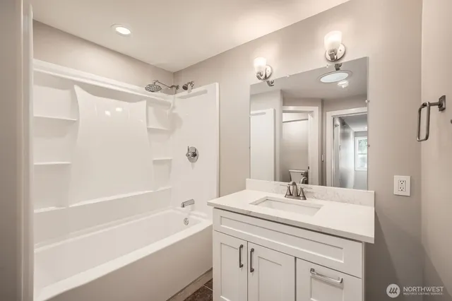 a living room with furniture a bookshelf and a window