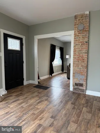 a view of a livingroom with wooden floor and staircase