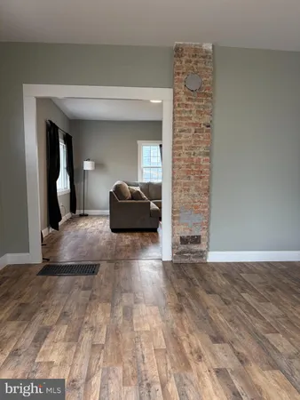 a view of an empty room and wooden floor