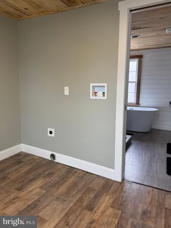 a view of a room with wooden floor and more windows