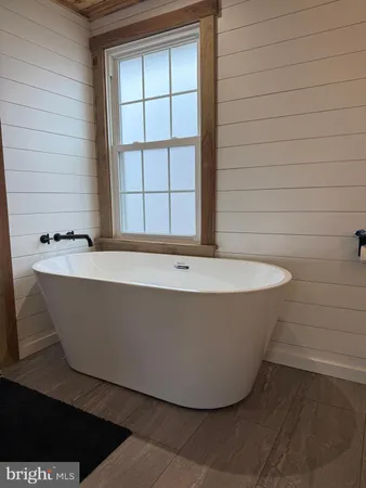 a white bath tub sitting in a bathroom